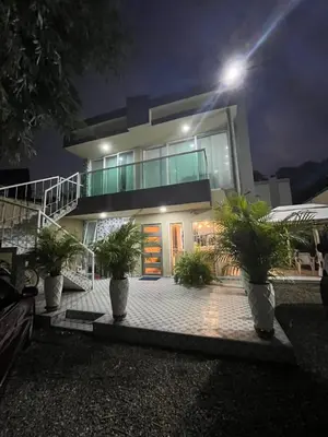 a house with plants in front of it at night at Lindo Apartamento en la Boquilla BBB 4 pax in Cartagena de Indias