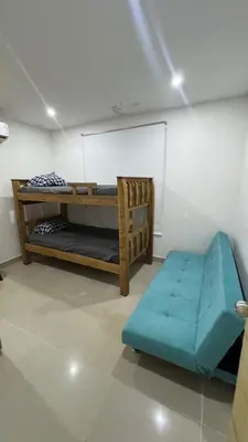 a room with two bunk beds and a bench at Lindo Apartamento en la Boquilla BBB 4 pax in Cartagena de Indias