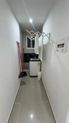 a small room with a white hallway with a small refrigerator at Lindo Apartamento en la Boquilla BBB 4 pax in Cartagena de Indias