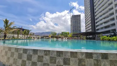 a large swimming pool in front of a building at Living Sunset by Santa Marina in Santa Marta