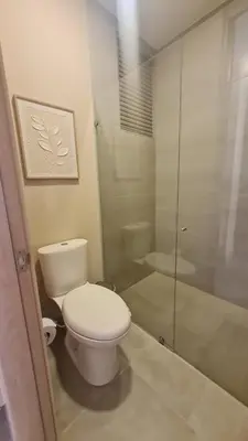 a bathroom with a toilet and a glass shower at Living Sunset by Santa Marina in Santa Marta