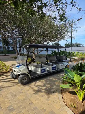 a golf cart parked in a parking lot at Living Sunset by Santa Marina in Santa Marta