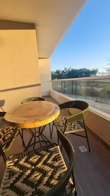 a table and chairs on a balcony with a view at Living Sunset by Santa Marina in Santa Marta