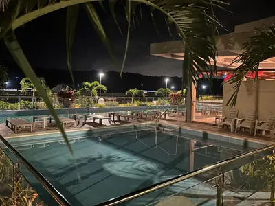 a swimming pool at night with tables and chairs at Cartagena 2 Hab con Terraza Privada Playa 12 min Parking in Manzanillo del Mar