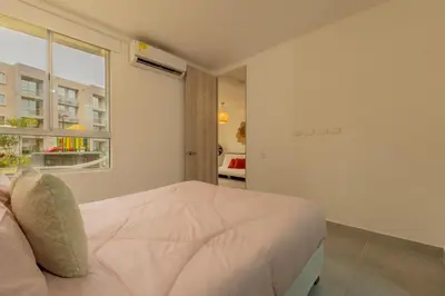 a white bedroom with a bed and a window at Cartagena 2 Hab con Terraza Privada Playa 12 min Parking in Manzanillo del Mar