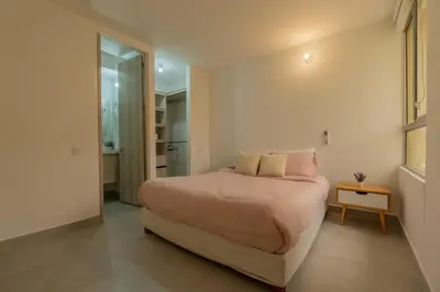 a bedroom with a large bed and a small table at Cartagena 2 Hab con Terraza Privada Playa 12 min Parking in Manzanillo del Mar