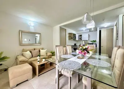 a dining room and living room with a glass table at Lindo apartamento a 5 minutos del mar!!! in Manzanillo del Mar