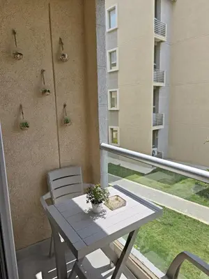 a table and chairs on the balcony of a building at Lindo apartamento a 5 minutos del mar!!! in Manzanillo del Mar