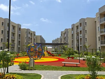 a playground in the middle of a courtyard with apartment buildings at Lindo apartamento a 5 minutos del mar!!! in Manzanillo del Mar