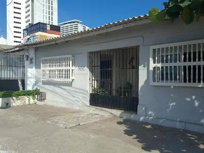 a white house with a gate and a building at Alojamiento Marbella Turismo in Cartagena de Indias