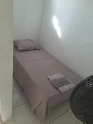 a small bed in a small room with a table at Alojamiento Marbella Turismo in Cartagena de Indias