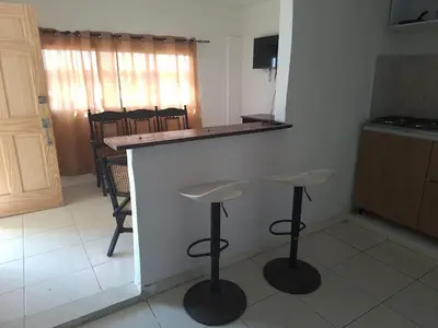 a kitchen with a counter and two stools in a room at Alojamiento Marbella Turismo in Cartagena de Indias