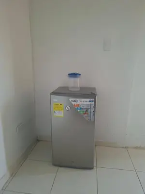 a small refrigerator in a corner of a room at Alojamiento Marbella Turismo in Cartagena de Indias