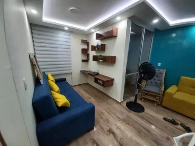 a living room with a blue couch and a chair at Exclusive Full Apartment in Cartagena in Cartagena de Indias