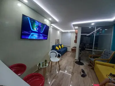 a living room with a tv on the wall at Exclusive Full Apartment in Cartagena in Cartagena de Indias