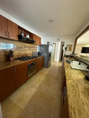 a kitchen with wooden cabinets and stainless steel appliances at Marabierto Beachfront Escape in Arizona