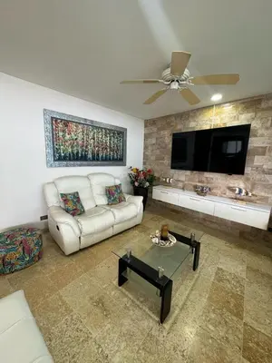 a living room with a white couch and a flat screen tv at Marabierto Beachfront Escape in Arizona