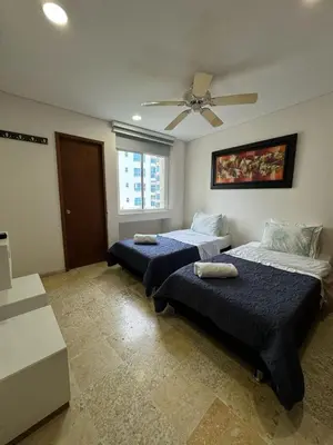 a bedroom with two beds and a ceiling fan at Marabierto Beachfront Escape in Arizona
