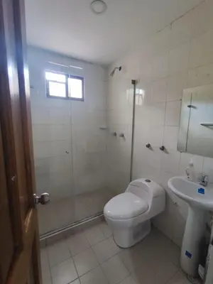 a bathroom with a shower and a toilet and a sink at Hotel Madeleine Norte in Barranquilla