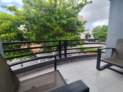 a balcony with two benches and a tree at Hotel Madeleine Norte in Barranquilla