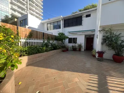 a courtyard of a house with plants and a fence at Casa Crespo Caribe Cartagena in Cartagena de Indias