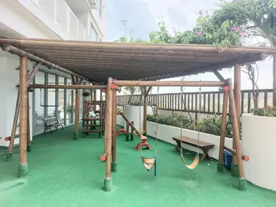 a wooden pergola with swings and benches on a balcony at Ikigai frente al mar con piscina infinita y Gym in Cartagena de Indias