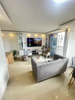 a living room with a couch and a flat screen tv at Apartamento en Barranquilla Alameda del Rio in Barranquilla