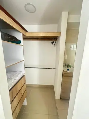 a small kitchen with white walls and wooden shelves at Apartamento en Barranquilla Alameda del Rio in Barranquilla