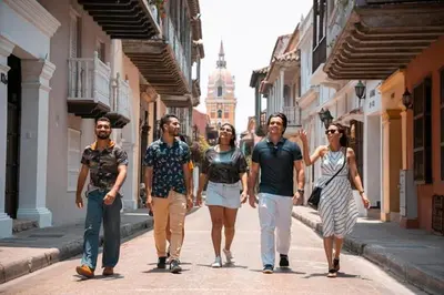 a group of people walking down a street at City Tour por Cartagena con entradas in Cartagena de Indias