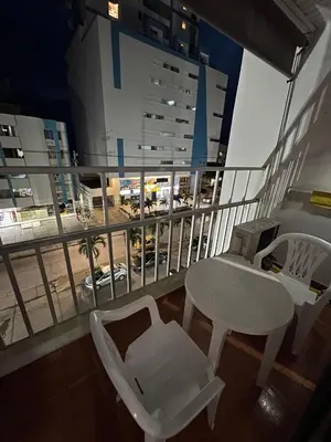 a balcony with a table and chairs and a view of a city at Apartamento turístico cerca al mar in Cartagena de Indias