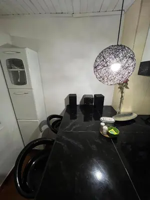 a black table with a lamp and a table with chairs at Apartamento turístico cerca al mar in Cartagena de Indias