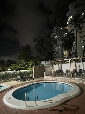 a swimming pool at night in a resort at Apartamento turístico cerca al mar in Cartagena de Indias