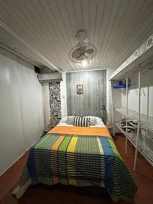 a bedroom with a colorful bed in a room at Apartamento turístico cerca al mar in Cartagena de Indias