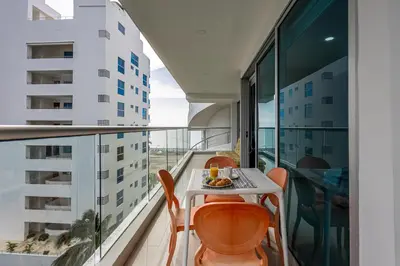 a balcony with a table and chairs on a building at Morros Malibu Beach - Con vista al mar in Cartagena de Indias