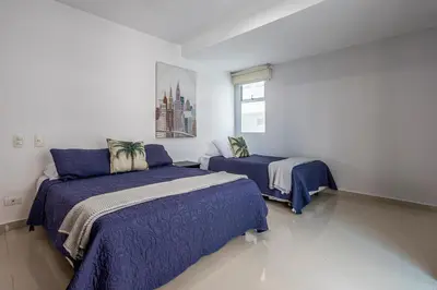 a bedroom with two beds and a window at Morros Malibu Beach - Con vista al mar in Cartagena de Indias