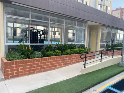 a building with windows and plants in front of it at Apartamento moderno para rentar por Días - Nuevo in Barranquilla