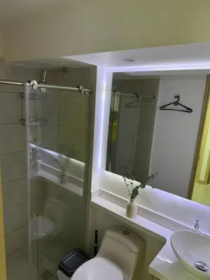 a bathroom with a toilet and a sink and a mirror at Apartamento moderno para rentar por Días - Nuevo in Barranquilla