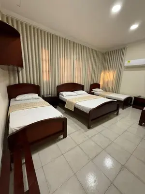 a bedroom with three beds in a room with curtains at Hotel Paseo Colon in Barranquilla