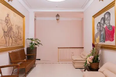 a living room with a couch and paintings on the wall at Hotel Paseo Colon in Barranquilla