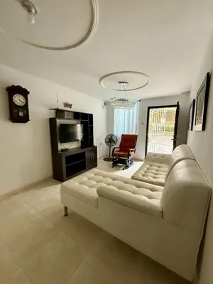 a living room with a couch and a table at First floor house in Barranquilla