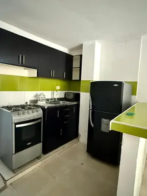 a kitchen with a stove and a refrigerator at First floor house in Barranquilla