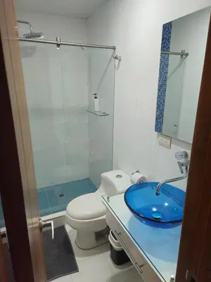 a bathroom with a toilet and a glass shower at Guest House with AC, close to Historical Centre 3 in Cartagena de Indias