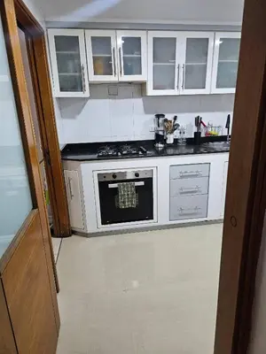 a kitchen with white cabinets and an oven at Guest House with AC, close to Historical Centre 1 in Cartagena de Indias
