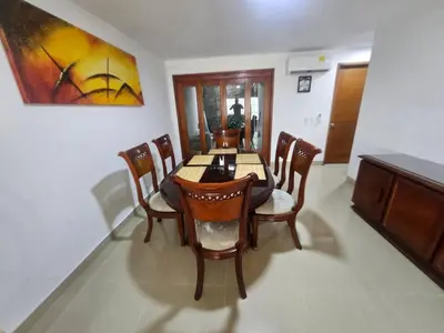 a dining room table with chairs and a painting on the wall at Guest House with AC, close to Historical Centre 1 in Cartagena de Indias