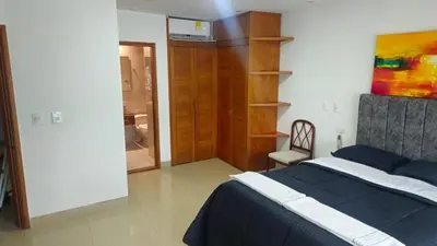 a bedroom with a bed and a chair in it at Guest House with AC, close to Historical Centre 1 in Cartagena de Indias