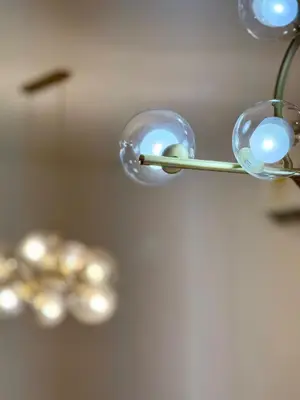 a chandelier with blue lights hanging from a ceiling at Luxury Apartment betwen Cartagena and Barranquilla in Juan de Acosta