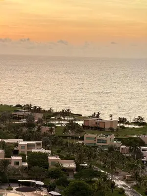 a view of the ocean from a resort at sunset at Luxury Apartment betwen Cartagena and Barranquilla in Juan de Acosta