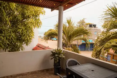 a balcony with a table and a view of the beach at Cabaña las Palmas Rincon del Mar in Rincón