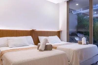 two beds sitting next to each other in a room at Deluxe en MorrosEos con piscina privada y salida a la playa in Cartagena de Indias