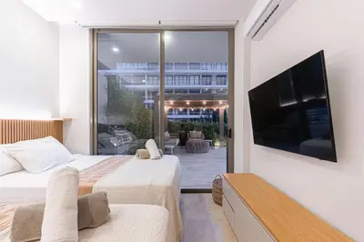 a bedroom with two beds and a flat screen tv at Deluxe en MorrosEos con piscina privada y salida a la playa in Cartagena de Indias
